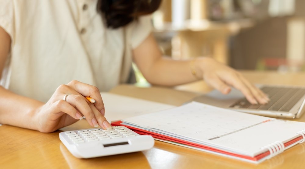 close,up,young,woman,hand,press,on,calculator,and,open